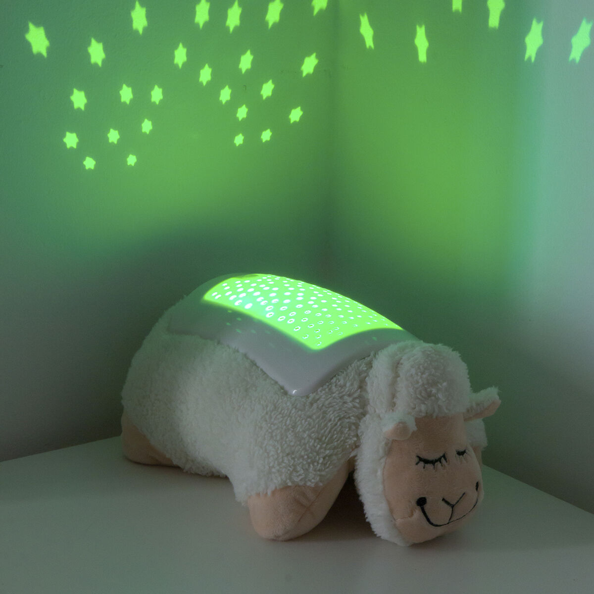 Plush Toy Projector Sheep InnovaGoods with green star projection in a cozy room setting.