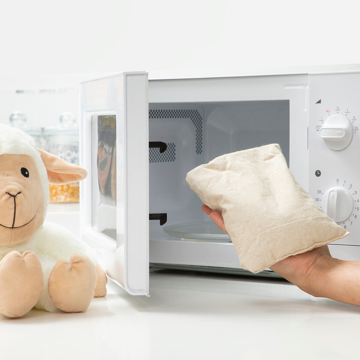 Sheep Soft Toy with Warming and Cooling Effect Wooly InnovaGoods near microwave with warming pouch.