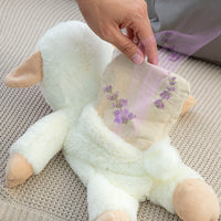 Hand inserting a cooling pack into the Sheep Soft Toy with Warming and Cooling Effect Wooly InnovaGoods.