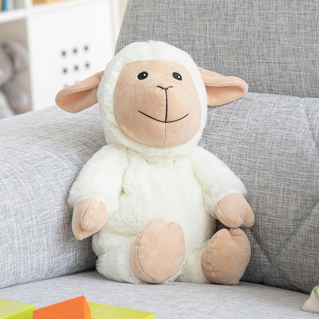 Sheep Soft Toy with Warming and Cooling Effect Wooly InnovaGoods sitting on a couch with colorful toys.